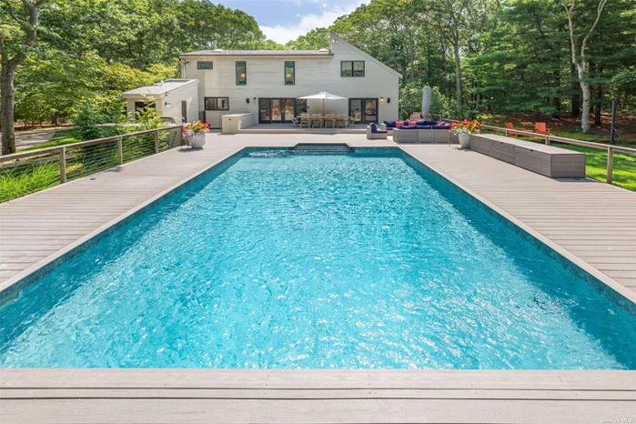 Privately situated in the Northwest Woods of East Hampton on two acres sits this perfectly designed and decorated 3 Bedroom and 3.5 bath property. Entering this dramatic you are greeted by a generous foyer and renovated half bathroom. As you proceed further, the heart of this home is its expansive living area, where the kitchen, dining, and living spaces meld seamlessly, promoting a sense of togetherness and connectivity. In addition, there is a beautiful den/sunroom area that bathes in natural light on the first floor as well as two guest bedrooms with a shared bathroom. Proceeding to the second floor there is a large primary bedroom with oversized bathroom and an outdoor roof deck that is perfect for morning coffee. Also on the second floor there is a small room that can be used for an office or additional guest sleeping. Outside you are greeted by the large heated pool and expansive deck area with outdoor kitchen which is perfectly designed for summer living and enjoyment. In addition to expansive outdoor living area, there is basketball court not only provides a recreational outlet but also adds a dynamic and active element to the property. Both inside and outside kitchens add elements of luxury and versatility, catering to various preferences and lifestyles. Whether it&rsquo;s a summer barbecue by the pool or a cozy indoor gathering during colder months, the home seems well-equipped for diverse entertaining options. If you are looking for a newly decorated, pristine rental that is perfect for the summer, look no further. Come and enjoy