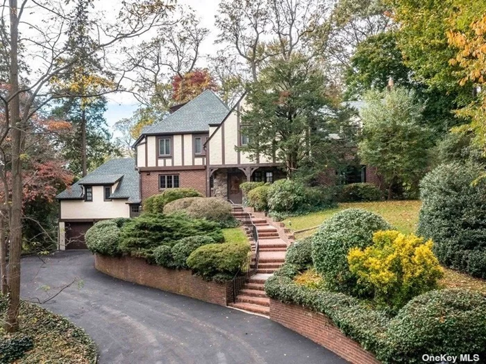 Stately Brick and Stucco center hall Tudor set in the heart of Port Washington Estates proudly sits on a lush half acre. This Grand residence boasts 6 bedrooms and 4.5 baths. The entry hall welcomes you to an oversized living room with stone fireplace, Banquet sized dining room, eat-in kitchen, family room with fireplace, powder room, guest room, full bath and an office. The second floor has a generous sized primary Bedroom with bath plus 3 additional bedroom and 2 full Baths. Full Basement with rec room and stone wood burning fireplace. Hardwood floors, Beautiful moldings, 2-car attached garage, CAC, gas heat. Port Washington Estates includes access to a private sandy beach with mooring rights (association fee). Close to town, Manhasset Bay, and LIRR to Penn Station and Grand Central Station.