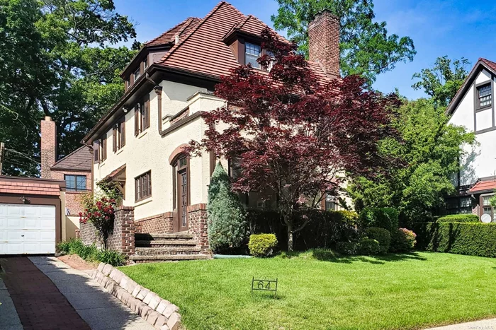 Detached Atterbury tapestry brick Tudor in a prestigious location on Groton Street in the heart of Forest Hills Gardens. This center hall Tudor home exudes charm, beauty, and simple elegance and boasts five bedrooms, three full baths, two half baths, a semi-finished basement, a private driveway, one car garage, terrace, an enclosed sunroom at the front of the house, and a private patio to the rear of the property. The house has been lovingly maintained to keep the intrinsic beauty of the character of this classic example of architectural excellence. The original details such as the unrivaled and masterful woodwork, the moldings, pocket doors, and oak flooring are all in pristine condition. There is a seamless flow of the rooms and a peaceful feeling that transcends this lovely home. The living room is inviting and has as its focal point, a large brick wood burning fireplace, perfectly framed on either side with original custom built in chests. There is a symmetry and a graceful sense of balance to the design of each room which is accented with French doors and Tudor framing. Off the living room is a library with built in bookcases, which adjoins to a sunroom facing the front of the residence. It is a lovely room with plenty of light and radiant heated floors. The formal dining room, which is generous in size and able to accommodate a large gathering, is ideal for family entertaining. It has elegant pocket doors separating it from the center hallway and foyer. The eat-in kitchen with its country French style, is bright and cheerful with French double doors opening to a private bricked patio. Off the kitchen, there is a powder room, and a staircase going down to the basement. The second floor has a large landing with a wide hallway and magnificent original oak flooring. The primary bedroom with ensuite bath has built in custom cabinetry and lovely windows with picturesque views of the trees and the sky. Off this bedroom, is an alcove with a dressing area, and a charming Dutch door opening to a terrace. There are also two more bedrooms on this floor and a full hallway bath. The third floor has two additional bedrooms and a full hallway bathroom. Both bedrooms have high ceilings, and lovely window views of the outdoors. The semi-finished basement has a large main room with an exercise swimming pool. Additionally, there is a separate laundry room, a powder room, a large storage room and a utility room. Egress from the basement to the outside is through a dedicated doorway and a stairway which is by the side of the house. An easy commute to midtown Manhattan, Forest Hills is just one train stop via the Long Island Rail Road with trains going directly to Penn Station or to the newly announced Grand Central Madison station in less than 15 minutes as well as service via NYC MTA bus and express subway to the city. It is also situated midway between LaGuardia and JFK airports and is convenient to all major highways in the area.Additional community amenities include excellent schools, many unique restaurants and shopping along fashionable Austin Street, Forest Park with miles of running and biking trails, playgrounds and golfing, and the world famous West Side Tennis Club with tennis, pool and fine dining for members.