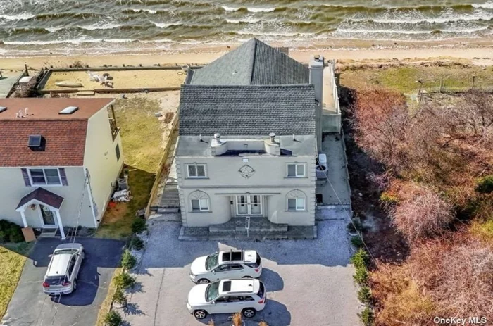 Location, location, location ! This unique waterfront home, located on Bellport Bay, offers 3, 000 square feet of contemporary living with private beach. As you enter this home, you will immediately be amazed by breathtaking views of the beach and bay. Imagine relaxing under the pergola on the backyard sand patio or stepping down to enjoy the private beachfront. You can swim, sun, boat and more, all within the privacy of your own home.  Inside, you will find a galley kitchen with plenty of cabinet space, full bath, laundry room, a spacious dining area, sunken living room with fireplace and comfortable four-season sunroom with fireplace, ductless min-split system and wall-to-wall windows overlooking the bay. The spiral staircase leads to a spacious 2nd floor primary suite with mirrored bathroom, large walk-in-shower, soaking tub and another enclosed sunroom also surrounded by wall-to-wall windows overlooking the bay. Located less than 2 miles from Smith Point Beach/Marina and close to transportation, shopping, the Hamptons, Fire Island and New York City, this one-of-a-kind home offers endless possibilities for those who enjoy magnificent sunsets, swimming, sunning, boating or just relaxing as you listen to the sounds of the waves. Take advantage of this rare opportunity to own a beachfront home on Bellport Bay.