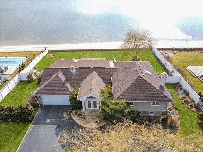 Custom-Built 3-Level Home on the Great South Bay with 114 Ft of 5-Year-Old Bulkheading. Enter into the Foyer Which Leads via French Doors into the Living Room with Cathedral Ceiling, 4 Skylights and Fireplace, Formal Dining Room with a Tray Ceiling and Triple Sliding Doors to Backyard, Den or Office with Sliding Doors to Backyard with Full Bath with Tub & Skylight & Eat-in-Kitchen with Four Seasons Greenhouse and Granite Countertops. 2nd Floor Leads to Master BR w/MBath, 2 WICs and Doors to Deck, 2 More Bedrooms & Full Bath with Skylight. Lower Level has Den with Door to Backyard Patio, 4th Bedroom, Full Bath with Shower & Laundry Room. 2-Car Attached Garage with Pull-Down Stairs to Attic * Interior Access. Flood Insurance Under $1, 900! Needs TLC to Make this Your Perfect Home with Views of the Great South Bay Galore
