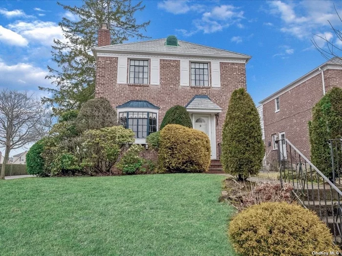 All brick corner property colonial on lovely street in Fresh Meadows. Large open rooms, high ceilings, hardwood floor in excellent condition, and detached garage. Full basement. Three large bedrooms upstairs plus den/office/4th bedroom on first floor. House being sold AS IS.