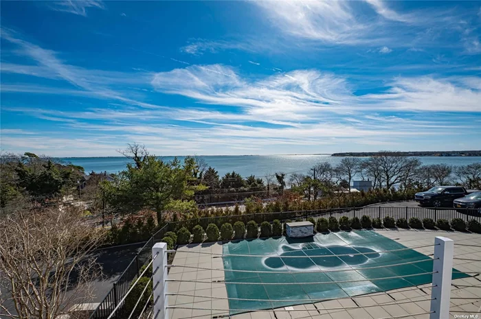 Welcome to your slice of paradise in Hampton Bays, boasting spectacular views of Shinnecock Bay. This home dazzles with its bright open floor plan, highlighted by 9-foot glass doors opening onto a deck showcasing million-dollar views. Relax in the living room with vaulted ceilings and a cozy fireplace, entertain in the formal dining room, or gather around the 6-foot island in the spacious kitchen. With three bedrooms, including a serene en-suite with full bath and water views, comfort abounds. Outside, indulge in the in-ground pool with a waterfall and wrap-around trex decking. Ample parking awaits guests in the driveway, while proximity to beaches, fishing, and golfing ensures endless outdoor enjoyment
