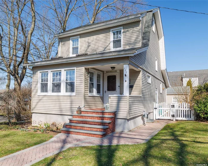 Come see this beautiful corner colonial located in the desired West End of the village of Floral Park. This lovely home has three bedrooms and two full bathrooms, a living room attached to a sunlit den and an open kitchen. The dining room features sliding doors that lead to the outdoor patio - the fenced-in yard has mature landscaping for privacy. This home has a walk-up attic and a finished basement with outside entrance. Other features include a welcoming front porch, a private driveway with garage & in-ground sprinkler system. Fabulous location just blocks to L.I.R.R., shops and restaurants. Floral Park-Bellerose schools.