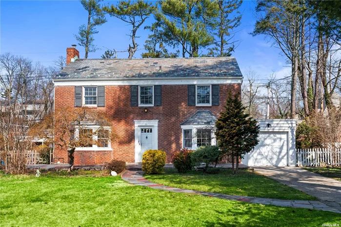 Discover the charm of this inviting Colonial, perfectly positioned in the tranquil South Strathmore area of Manhasset. Facing south, this property is drenched in sunlight, creating a bright and welcoming atmosphere in every room. It features four bedrooms, three full bathrooms, a den, a first-floor office, and a newly updated kitchen that opens up to a living area with a wood-burning fireplace, ideal for cozy gatherings. The basement is finished, adding to the versatile space this residence offers, while the attic is fully insulated for enhanced comfort. The property is complemented by a durable slate roof, ensuring timeless appeal and protection. Enjoy the abundance of natural light and the unique charm this delightful dwelling provides.