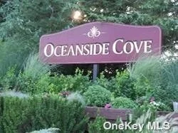 Oceanside Cove - Ground Floor 1 Bedroom Unit offering Living Room/Dining Room With Sliding Glass Door To Private Deck, Efficiency Kitchen, Bedroom w/walk-in closet, Updated Full Bathroom,  24/7 Security, Club House, Gym, Sauna, Tennis Courts, In Ground Pool, Library, Play Grounds and more!