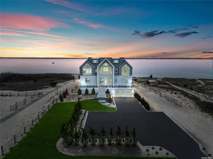 Transcending the notion of a mere home with an exquisite blend of timeless design and contemporary elegance, this newly constructed Nordic Modern Beach Home by First Dunes stands as a testament to coastal luxury living, offering a lifestyle of serenity and sophistication. Indulge in the breathtaking direct access and views of Moriches Bay from the moment you enter the grand foyer adorned with a bespoke glass-wrapped staircase that ascends like a work of art, setting the tone for the elegance that awaits within. The main level invites seamless indoor-outdoor living, with sweeping bay views serving as the backdrop to the open-concept living and dining areas. A chef&rsquo;s dream kitchen, outfitted with top-of-the-line Gaggenau and Thermador appliances, beckons culinary creativity, while the adjacent living room features a porcelain-wrapped fireplace and expansive sliding doors leading to your private outdoor sanctuary. Relish in the tranquility of the master suite on the second level, complete with vaulted ceilings, a private balcony, and a spa-like ensuite boasting ocean views. Two additional bedrooms on this level offer their own luxurious retreats, each with ensuite bathrooms and privacy. The third level offers two additional bedrooms with ensuite bathrooms and a bonus room, providing ample space for guests and leisurely pursuits. Every facet of this exceptional residence exudes craftsmanship and refinement with an array of coastal details ensuring the highest standards of resilience, durability and safety. The beautifully landscaped grounds lead to a four-car garage and additional storage underneath the home, offering practicality without compromising on aesthetics. Elevate your lifestyle to new heights as you embrace the coastal essence you&rsquo;ve always desired. For those with a passion for waterfront living, this property grants deeded ocean access unlocking a world of relaxation and water sports and direct access to Moriches Bay for fishing, clamming, swimming and boating including space for a mooring. In a locale where new construction opportunities are rare to come by, this home stands as a testament to unparalleled craftsmanship and coveted coastal living catering to the discerning buyer.