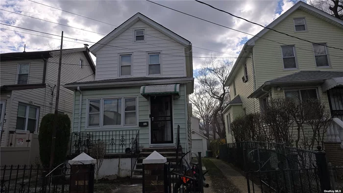 One family sits on a 30x100 lot and comes with three bedrooms, a basement, an enclosed porch, a sunroom in the rear, a private driveway, and a one-car garage.