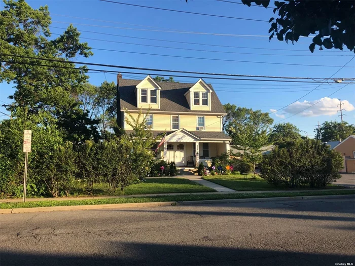 Classic 2 family colonial in downtown Wantagh. Fantastic corner location with great exposure and visibility. Close to shopping and railroad. Building consists of two apartments each with 2 bedrooms and 1 bath. Each unit has individual gas and electric meters as well as in unit washer and dryer combos. Recent updates include new windows and siding, inground sprinklers, Belgium block and Blacktop driveway and 2 new gas boilers. Each apartment has a front porch, there is a common back yard and plenty of onsite parking. There is a very large unfinished attic with staircase access that can be finished into additional living space and an unfinished basement with outside entrance that can be used for storage. T. Possible seller financing available