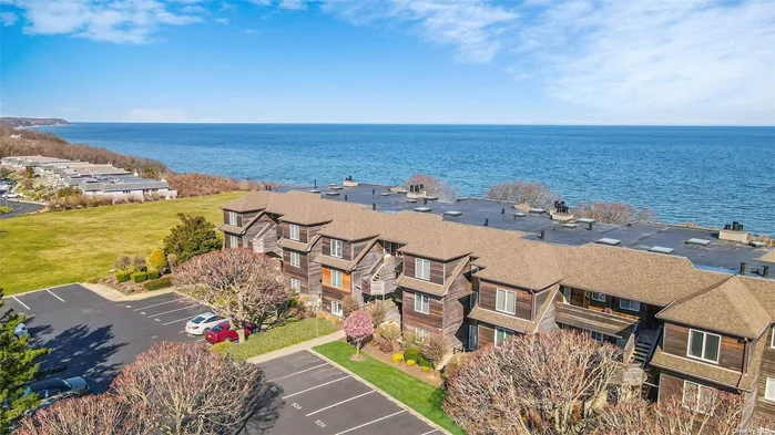 Bright and airy 1st floor condo located in the desirable Bluffs offers Large deck with Incredible views of the Long Island Sound. New flooring and paint makes this unit move in ready! Features Kitchen with dining area, great room with fireplace with walls of glass offers breathtaking views of the LI Sound. Access to private beach. Primary bedroom with Full bath, 2nd bedroom and 2nd bath. Resort living all year with Pool, clubhouse with gym , tennis and pickle ball courts. Close to all the North Fork has to offer including renowned wineries, restaurants and shopping!