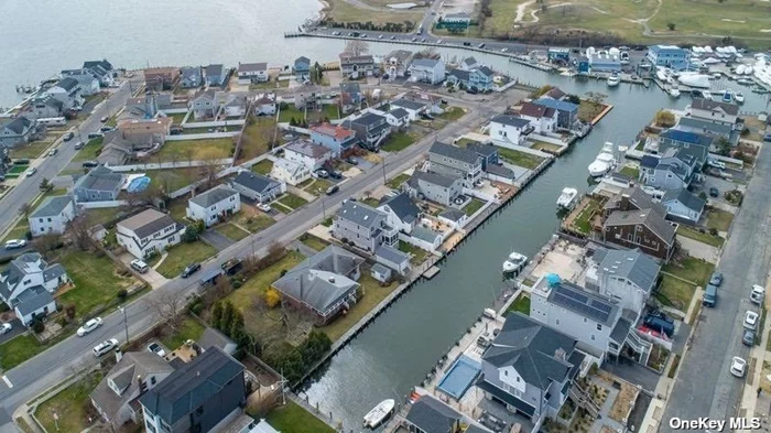 Updated raised colonial home on a 60-foot-wide canal right off the Great South Bay minutes from Fire Island and local beaches. This home is a boater&rsquo;s dream being the first canal off the bay. The 40x100 lot features 40 feet of new navy bulkheading, shore power for your boat, along with a raised property and flood Insurance premium of $417.00a year. The large open first floor plan is great for entertaining or relaxing in the comfort of your home enjoying the beautiful canal right in your own backyard with a convenient first floor bathroom for guests. The second-floor features four bedrooms and two baths with a large primary on suite with a walk-in closet and fully renovated primary bathroom with a large soaker tub. Off the primary suite there is a balcony which leads to the rooftop deck that features a panoramic, scenic view of the Great South Bay, the Robert Moses Bridge and the Fire Island Lighthouse. The home includes all energy efficient appliances, central air, fully paid off solar panels and a level 2 EV charger conveniently located in the driveway. Enjoy your morning coffee on the comfort of your full width front porch or on the rooftop deck with breathtaking views. The very large 24&rsquo;x36&rsquo; two car garage features an indoor and outdoor living room with heat and air conditioning along with space to park your cars. The backyard has a large, covered patio great for entertaining with easy access to a second refrigerator, sink and cabinets as well as a gas grill hookup to make grilling easy for the beautiful Long Island summers.
