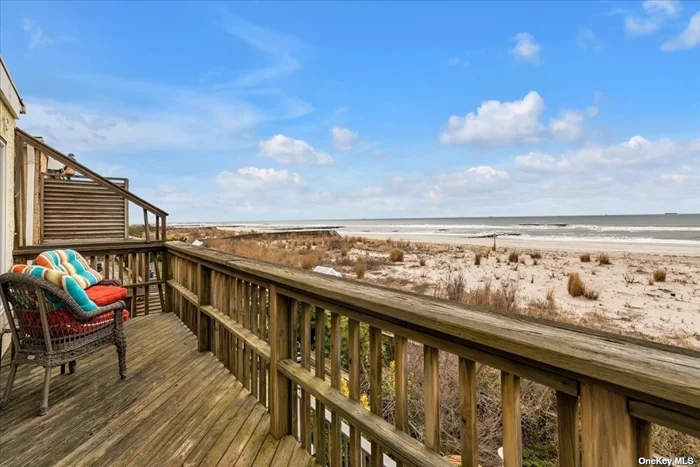 Enjoy the fresh salt air in this magnificent home right on the oceanfront. Amazing views of the Atlantic abound from private decks on all 3 levels, including one right off the primary suite, one on the main level and one right on beach level. The primary suite features a fireplace and a brand new bathroom with radiant heat flooring, and there are 4 additional spacious bedrooms with space to add a sixth. An expansive open-plan living/dining room is full of natural sunlight, and also has a fireplace. The updated kitchen boasts quartz counters and stainless steel appliances with modern cabinetry. A large 53 x 100 buildable lot is attached to the property. Located in the trendy west end, steps away from the beach and the best restaurants and shops in Long Beach.