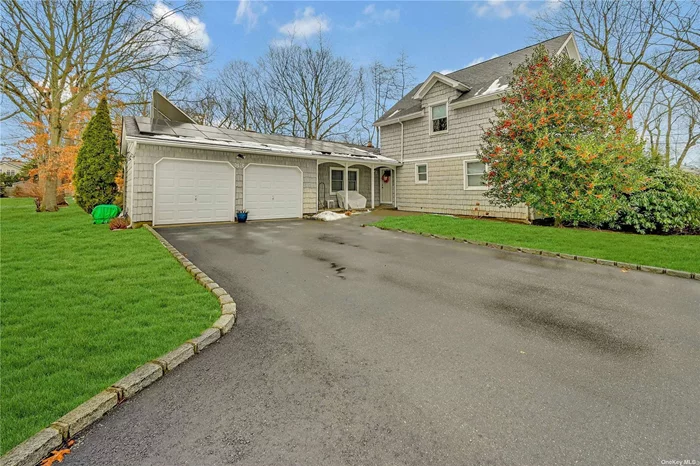 This meticulously maintained farm ranch located in the Smithtown Central School District. The home offers a welcoming floor plan. The main level features an over-sized great room with vaulted ceiling, a wood burning fireplace/stove and access to an expansive deck overlooking the large level backyard, a basketball court, a recently renovated eat in kitchen with stainless steel appliances, a gracious formal dining room with access to patio and a large first floor primary bedroom with en suite, walk-in closet and two additional closets. The second level is comprised of 2 generous bedrooms, one full bath with tub and an office that could be a 4th bedroom. This house has many improvements including owned solar panels for electricity and hot water. Loads of Storage on all levels. Conveniently located near schools, restaurants and shopping.