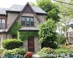 Large corner, English Tudor, building size: 20X42, 10 ft. ceilings, detached two car garage. private rear entrance to high ceiling basement, Extremely well located, convenient to Everything...