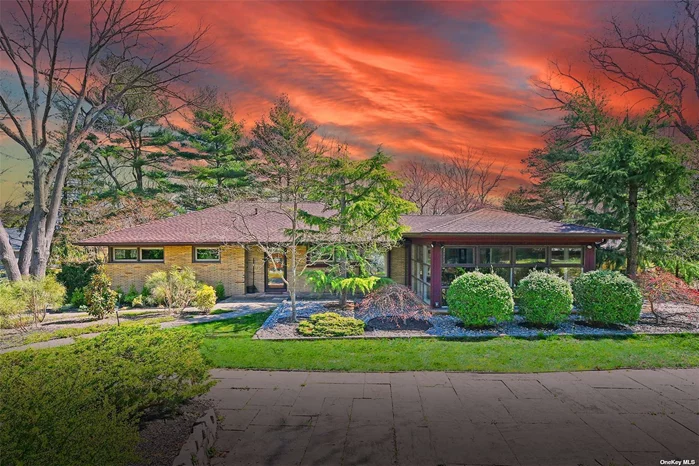 Discover the harmony of this Frank Lloyd Wright inspired mid-century modern home in the vibrant beach community off West Shore Road in Huntington. This Classic updated Mid-Century Modern ranch home with sleek lines, steel and concrete construction where natural light abounds bringing the outside beauty inside with two levels of living space.Tall ceilings, open spaces, totally updated with fine finishes, mostly new windows, nooks and crannies, 2 stone wood burning fireplaces, wood floors, Gas heat, IGS, CAC, 2 car garage, full finished lower level with sliding patio doors to the bluestone patio and resort style 20x40 IGP-perfect backyard for relaxing, entertaining and summer fun in a very private landscaped setting! 1st level features updated kitchen, formal dining room, den, family room with wood burning fireplace, Master ensuite with renovated bath and walk-in-closet, 2 additional bedrooms and brand new family bath.The lower finished level with slate floor, high ceilings, spacious 2nd family room with oversized wood burning fireplace, guest bedroom or office/study, full bath, laundry room, summer kit and all the conveniences of a poolside cabana. Manicured.37 acre property with colorful mature specimen trees and plantings throughout this exceptional home! In addition, the Anoatok Beach Association on Huntington Harbor-dock, mooring , kayak storage, block parties, gatherings, various social events, boating and summer recreation! ($300 dues.) Just minutes from vibrant historic Huntington Village known for its parks, night life, fine dining, small eateries, boutique shops, museum, Fine Arts, YMCA, concerts and much more!. LIRR/1 hour to NYC/Grand Central and Penn Station