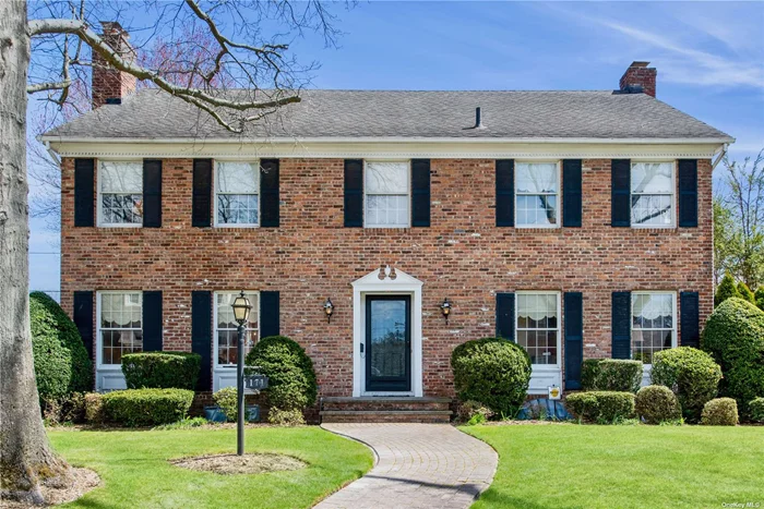 Welcome to this magnificent all-brick center hall colonial nestled in the prestigious estate section on a private 80x100 lot. Enter through a gracious foyer to discover over 3000 square feet of living space starting with a welcoming foyer leading to a formal living room with a wood-burning fireplace and a spacious formal dining room. The heart of the home, a generously proportioned eat-in kitchen, provides the perfect backdrop for culinary delights. The first floor continues to impress with a sizable family room featuring another inviting wood-burning fireplace, a convenient wet bar for effortless entertaining, a private office space for productivity, a full bath for added convenience, and a laundry area. A spacious second floor boasts a primary en-suite with a walk-in closet and an additional closet, four additional bedrooms, and a hall full bath. Step outside to the beautifully manicured outdoor space which includes a brick patio just perfect for hosting summer garden parties and barbeques. Completing the outside is an all-brick two car detached garage. Close proximity to parks, schools, shopping, and two LIRR train lines. Award-winning Garden City School District.