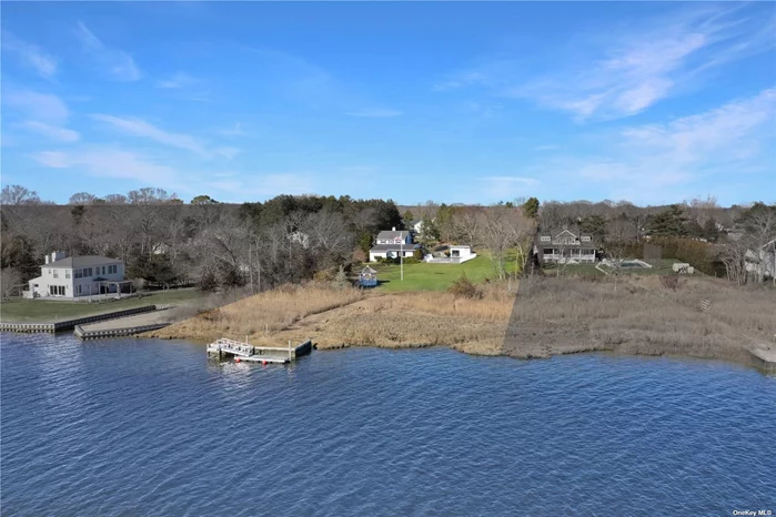 Discover your waterfront sanctuary on the sought-after Sunset Avenue in East Quogue. This spacious 2, 800 sq ft home sits on 2 acres of prime real estate, boasting expansive southwest backyard with nearly 200&rsquo; of water frontage. Your boating adventures await with a deepwater floating dock with direct access to Shinnecock Bay (built in 2017), while the two-car detached garage provides added convenience and storage for automotive and all sorts of toys alike. Step inside to discover a light-filled living room offering stunning water views while enjoying just as much sun on your face as you gaze at your 20x40 foot Gunite Pool from the Sun Room, perfect for relaxation and entertainment. A cozy fireplace in the additional sitting area adds warmth, charm and additional entertaining space. The first-floor primary ensuite provides a private retreat, with the primary bathroom recently renovated in 2023. Outside, by the Pool awaits sunny days and tranquil evenings, accompanied by a pool house featuring full bathroom amenities and an open kitchen, ideal for hosting gatherings. Upstairs, four additional bedrooms, and two bathrooms offer ample space for family and guests. This property exudes charm, comfort, and waterfront living, making it a true gem in The Hamptons.