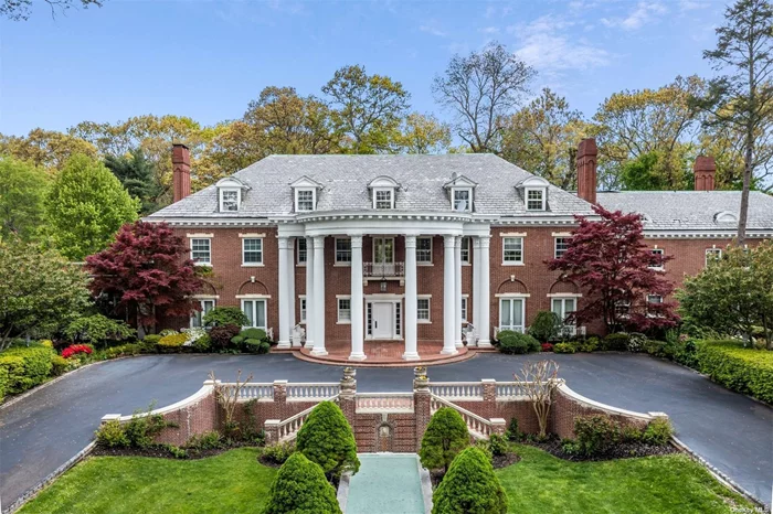 This breathtaking Georgian revival Mansion is one of the original historic estates of the Gold Coast, crafted by the renowned architect Henry Otis Chapman, surrounded by an impressive 5.25 acres of immaculate lawns and mature, exquisite plantings. The centerpiece of the estate is the awe-inspiring two-story center block, flanked by two expansive wings, all beautifully rendered in brick with a classic slate roof. As you enter through the grand two-story bowed portico, you are greeted by a remarkable 13-bedroom, 7-full bath, and 2-half bath home featuring six exquisite fireplaces, showcasing exceptional workmanship and the finest materials. The chef&rsquo;s kitchen is equipped with both electric and gas cooktops, a Thermador double oven, and a Bosch dishwasher. It opens up to a grand formal dining room adorned with a hand-carved fireplace, a hand-painted ceiling, custom molding, and stunning oak wall paneling with inlaid hardwood flooring. Across the grand center hall, a magnificent living room awaits, complete with a grand fireplace, custom arched floor-to-ceiling windows, and built-in lighted displays in each corner. The adjacent garden-style sitting room boasts custom plaster molding and hand-painted details leading to a picturesque brick patio with an incredible in-ground saltwater pool. For modern-day convenience, the estate offers a convenient three-car garage. This extraordinary property is truly a must-see for anyone seeking a timeless and magnificent estate on Long Island&rsquo;s highly sought-after Gold Coast.