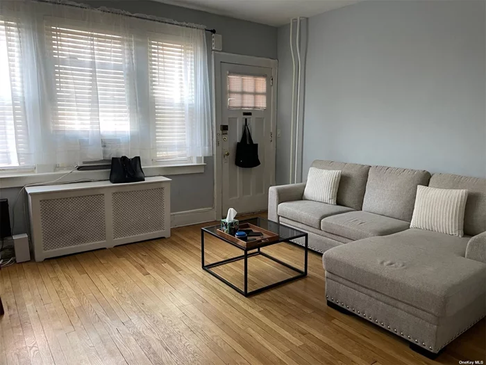 Spacious and bright updated apartment on first floor. Hardwood floors. Unit ACs in windows. Living room, eat in kitchen, bedroom, bathroom. Walk in closet. Assigned parking available. Landlord pays for water. Tenant pays electric, cooking gas and heat. No pets. No smoking. Two blocks to LIRR and Bell Blvd.