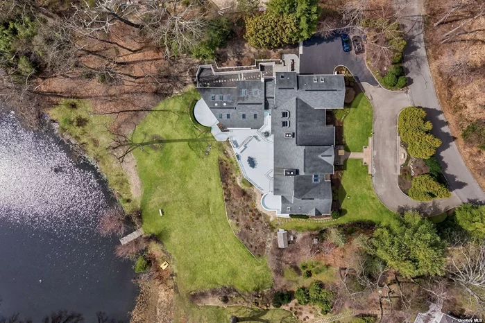 19 Mallard Drive, also known as Swans Cove, is a stunning western waterfront estate in Lloyd Harbor, New York. It boasts over 10, 000 square feet of living space, including an 3, 500 square foot finished lower level, and more than 2500 square feet of deck space, including a BBQ area, making it a luxurious and spacious home.  The building is 45 feet above the water, situated on a hill. No flood insurance is required.  The property is situated on a 2.78-acre lot with private beach access. A private boat dock and mooring is available at the Lloyd Harbor Village park Imagine relaxing on your private beach or cruising around Cold Spring Harbor and Oyster Bay in your boat.  The home interior features dramatic 20-foot high ceilings in the entry foyer, a 700-square-foot formal living room w fireplace, a 270-square-foot formal dining room, and a gourmet chef&rsquo;s kitchen with fireplace and top-of-the-line professional-grade appliances and a breakfast area. There is a bedroom and bath nearby.  The primary wing, where the Primary Suite is located on the main floor has a soaring ceiling and fireplace framed by huge windows that afford a light-flooded space with endless water views and nightly sunsets from its&rsquo; own deck with luxurious bath. A lower-level office/library form a part of the primary suite. The Top Floor has Three en-suites Bedrooms & an office.   An elevator goes down to the lower level/ entertainment and guest wing. It is comprised of a kitchenette and sitting room w/ fireplace, a movie theater and a large guest en-suite with tea-room that opens out to an enormous deck. All lower level rooms have dramatic waterviews  The entertainment wing is facilitated by an award-winning enclosed sky-lit pool house, a steam shower, a sauna, and two restrooms, including one handicapped accessible restroom.  The house has a total of three (3) fireplaces, nine (9) bathrooms, and six (6) en-suite bedrooms. With all these amenities, you&rsquo;ll always want to stay home!  This luxurious estate was completely rebuilt in 2009, and it offers the perfect escape from the hustle and bustle of everyday life. Minutes away is the Caumsett State Park with the Marshall Field waterfront mansion, equestrian center, and hiking trails. Village Park offers a western sandy beach, summer day camp, kiddie play-land, 6 tennis courts, a dock & mooring. Active village police ensure safety in this aspirational oasis. You can enjoy the peace and serenity of country living while close to Lloyd Harbor&rsquo;s amenities and the convenience of Huntington Town and LIRR.