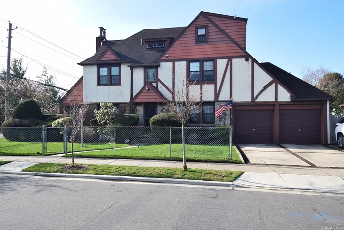 Beautiful center hall Tudor with large rooms. New Kitchen & Bath, very spacious, cafe booths in basement. Convenient 2 car attached garage and more. Must see! All info should be verified.