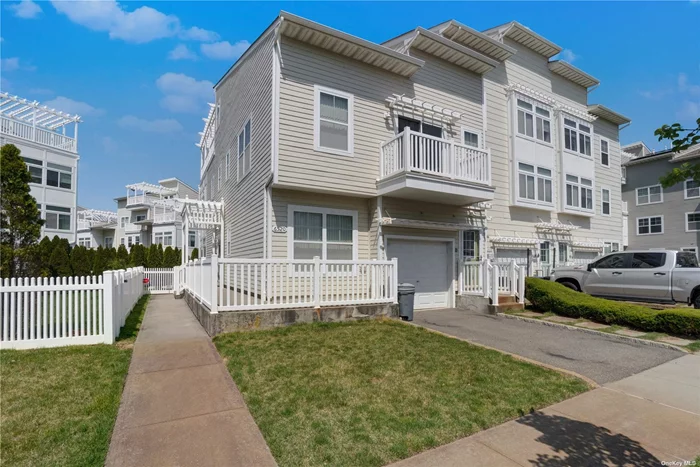 Here&rsquo;s an exciting opportunity to own a slice of New York City&rsquo;s coastal charm within the vibrant community of Arverne by the Sea! This legal two-family townhouse, the Grand Bahama model in the Dunes section, is situated just a few houses from the ocean and boardwalk, with convenient access to Manhattan via transportation just two blocks away. With 270 units in this thriving community and its proximity to JFK Airport, the location couldn&rsquo;t be more ideal. This end unit townhouse basks in natural light, showcasing a main unit with 3 bedrooms, 2 full bathrooms, a bonus room, and a rooftop terrace offering scenic views. The open-concept living and dining areas boast recessed LED lighting and elegant hardwood floors that span the entire property. Stepping outside through the patio doors, you&rsquo;ll find a beautifully landscaped yard featuring a tiled platform perfect for outdoor grilling, all enveloped by privacy-enhancing landscaping. Inside, the first floor boasts a full bathroom, a generously sized bedroom, and a laundry room with full-sized machines. Ample garage space and driveway parking add convenience for your beach lifestyle. The second floor houses two more spacious bedrooms and another full bathroom, while the third floor offers a versatile bonus room suitable for various needs such as office space, guest accommodations, or a home gym. And to top it all off, a spacious tenants unit of 1 bedroom, full bathroom and balcony, which is income producing. Don&rsquo;t miss your chance to experience coastal living at its finest!