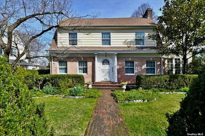CENTER HALL COLONIAL IN THE COVETED LANDMARK DISTRICT OF DOUGLAS MANOR. Classic and spacious features of a well balanced Center Hall Colonial from the architect Warren & Clark CIRCA 1925. Notable features include the brick walkway, columns, detached matching garage with loft and workshop area. Up-dated Eat-in-Kitchen with Bay window, followed by the powder room, and a bonus of a three season porch.  Traditional living room with fireplace followed up with French doors leading into the den. Timeless elegance underfoot with original hardwood floors throughout. The second level has three generous bedrooms and one bath followed by a walk up to a 4th bedroom and bath plus storage. There are 5 zones of gas heat and up-dated electrical panel. The basement is semi-finished with ample storage and workshop plus large laundry room. Lush fruit trees on property. The Manor Association offers use of a private dock, playground, as well as occasional concerts and a view of the Macy&rsquo;s fireworks. Easy access to the LIRR and local schools. This is a peninsula surrounded by Little Neck Bay and is not far from all means of transportation.