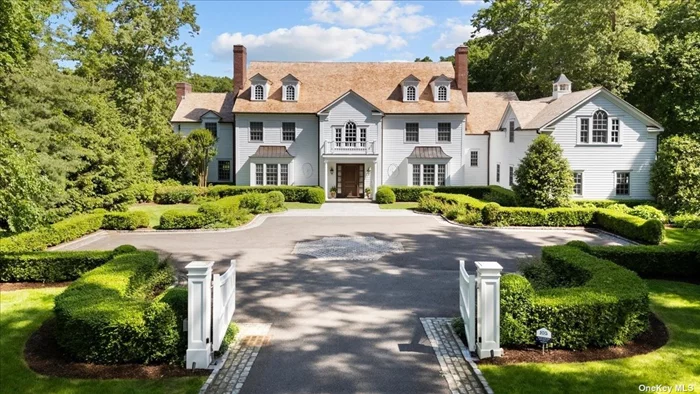 Welcome to 650 Chicken Valley Road. An idyllic setting nested in the exclusive Matinecock community on Long Island&rsquo;s Gold Coast. This private and expansive property is the epitome of timeless elegance. Just shy of 6 park like acres of meticulously manicured grounds, this custom-built colonial boasts unparalleled sophistication.  As you pass through the gated entrance and along the Belgium block-lined front courtyard, a dream home awaits. A brand-new cedar roof crowns the stately exterior, hinting at the impeccable craftsmanship and attention to detail found throughout.  Step inside and be greeted by the double-height coffered ceiling entry foyer which sets the tone for the elegance that unfolds. The first floor seamlessly blends classic charm with modern amenities, featuring a family room adorned with a fireplace and French doors that open to the backyard patio area, perfect for family gatherings or a peaceful retreat.  Entertain guests in the formal dining room, complete with its own fireplace, or the formal living room where French doors beckon to the covered patio area, offering an inviting ambiance for intimate conversations or alfresco dining. A sophisticated office space, also graced with a fireplace, provides an inspiring environment for work or contemplation.  The heart of the home lies within the gourmet kitchen equipped with top-of-the-line Wolf appliances including a 48 gas stove, double wall ovens with a warming drawer, microwave, and two sinks. In addition to a separate Sub-Zero refrigerator and freezer, the kitchen area includes 3 Bosch dishwashers, and a butler&rsquo;s pantry complete with a wine cooler and wet bar. This bright and welcoming space is a haven for the discerning chef and their guests.  The home conveniently has one first-floor bedroom with an ensuite bathroom, providing comfort and privacy for guests, service, or multigenerational living. It is perfectly located near a separate entrance and back staircase.  Ascend the main staircase to the second floor and find a broad and bright expansive hallway that leads you to multiple options for ideal relaxation. The master suite is a sanctuary unto itself, featuring his and hers walk-in closets and bathrooms, a steam shower, a sitting room or office space, and a private balcony overlooking the sprawling backyard oasis.  Continuing through the second floor, there are 4 additional bedrooms, each with walk-in closets and ensuite bathrooms, all offering unparalleled comfort and style for family and guests alike. An upstairs entertainment room or additional bedroom with an ensuite bathroom provides versatility for every lifestyle.  The unfinished basement (approx. 4, 000 sqft), with its tall ceilings and walkout access to patio and sports court presents endless possibilities for customization, from a state-of-the-art home theater to a luxurious spa retreat or wine cellar. Additionally, there is an unfinished walk-up attic adding another, almost 2, 000 sq. ft. of space.  Outside, the allure continues with an in-ground heated, gunite pool surrounded by mature plantings, rose bushes, and a blue stone patio. The pool includes a spa and an electronic cover which provides safety, cleanliness and ease.  In addition to its exquisite amenities, this home is equipped with a full home generator, a water filtration system, whole house Sonos entertainment system, security system, and a spacious 3-car garage, providing both convenience and peace of mind for discerning homeowners.  Ideally situated near upscale boutiques, gourmet restaurants, train station, esteemed schools, yacht clubs, and country clubs, you can experience the height of luxury living in this classic and timeless property. Every detail of this home has been thoughtfully curated for the most discerning buyer. This unique setting offers a lifestyle of unparalleled refinement and sophistication.
