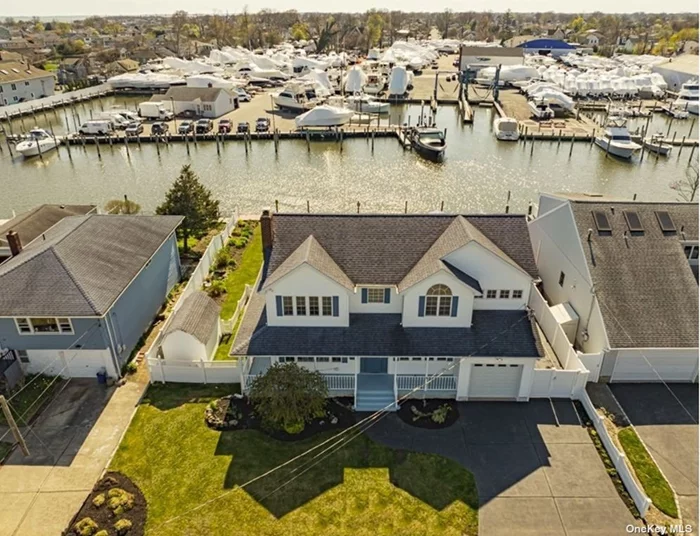 WATERFRONT. Bring the BIG boat to Lindenhurst&rsquo;s largest waterway and enjoy Key West sunsets from your backyard. Every room is S-P-A-C-I-O-U-S in this custom-built center hall colonial with a charming wraparound front porch. Dramatic vaulted ceilings, plenty of closets, and walls of glass await you. What are you waiting for ?