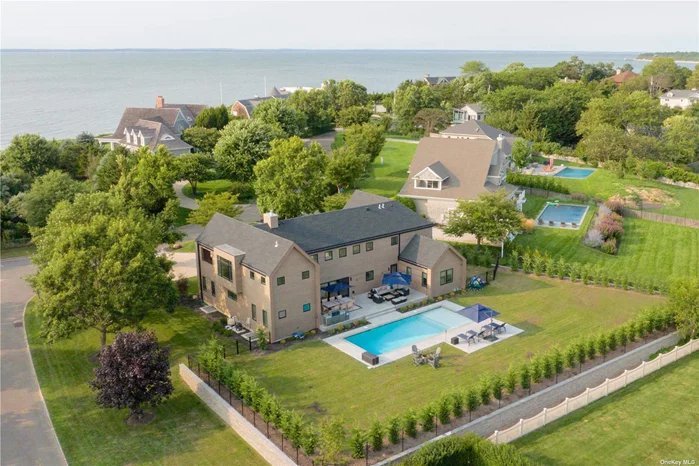 2025 Rates: MDW-LD $142, 500; June $30K; July $52, 500; A1-LD $55K. This Modern Hamptons style home offers everything you could ask for from a Summer retreat to the East End. Featuring over 3500sqft of living space, the impressive Great Room is the centerpiece of the house and flows seamlessly to the rear yard which features a 20x40 heated gunite pool with sun deck, large architectural stone patio w/ fire-pit and large gas fired grill. In addition, you will enjoy lazy summer walks to the Rock Cove Estate community private Sound side beach and peak-a-boo water-views from the second floor. All bedrooms are generously proportioned but the Primary En-Suite is truly spectacular with high vaulted ceilings, private waterside balcony, walk in closet and En-suite full bathroom. Bonus feature, the second floor offers a game/media-room w/ full-size pool table, shuffle board table and waterside balcony. Don&rsquo;t let this amazing offering slip away!