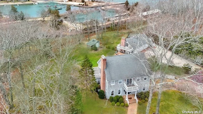 Boaters Delight. This Bayview waterside estate sits on nearly 2.5 acres of secluded property in the coveted Shellfisher Preserve association comprised of three spectacular custom homes. Water views and 300 feet from your private deeded bay beach and your own 70&rsquo; long deep-water stationary dock in a private marina. The property is flanked by a spectacular 650&rsquo; long deep water, tidal lagoon owned and maintained through the Peconic Land Trust. This traditional style home was custom built, ground up and features 3 bedrooms upstairs with large master suite, possible first floor bedroom or den. Huge, detached 1, 800 sqft post-and-beam barn style garage with room for 3 cars and finished studio space above with exquisite water views. Site plan with room for a 20x40 Gunite pool in the large grassy and level backyard which is fully deer fenced.