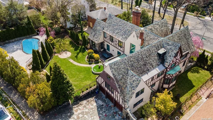 AN EXQUISITE HOME WHERE EVERY DETAIL TELLS A STORY This historic English Tudor exudes elegance and has been meticulously designed to reflect a commitment to quality and excellence, a task the owner spent 4 years perfecting. Spanning 7, 987 sq. ft. with 4 bedrooms and 4.5 baths, this home is designed for living on a grand scale. You&rsquo;ll be amazed by the intricate design of the custom wrought-metal banister and chandelier, the expertly hand-painted murals and domed ceiling with cove lighting commissioned by Russian artists. The elaborate crown moldings are a true work of art and a signature component of every room. The home&rsquo;s ballroom is a sophisticated space with a combination of a grand marble fireplace, and crystal lighting. Beyond the pillars, you&rsquo;ll find a sunlit grand piano room with oversized windows. With its expansive size, the formal dining room provides ample space for hosting lavish or intimate gatherings and is crowned with a striking Murano glass chandelier. The inviting kitchen has solid wood cabinets, paneled appliances, a wine cabinet, granite countertops and handcrafted plaster moldings. The half-bath finishing touches include a gold-plated sink. Retreat into the elegance of the mahogany-clad library or cigar room equipped with humidor, wine temperature-adjusted cabinet, along with wood-burning fireplace. The main bedroom is a sight to behold with a stunning cove ceiling, plasterwork detail. The en-suite bath offers the comforts of a jacuzzi, stand-up shower, bidet, and a makeup room. Additional amenities include a fully equipped woodworking room, a sauna, gym, billiard room, and 5 wood-burning fireplaces. The property extends from Midland to Radnor Rd, the entrance to the heated 3-car attached garage. Within the home&rsquo;s spacious 19, 843 sq. ft. lot is a newly refinished in-ground pool surrounded by a stone patio. This remarkable home has been recognized for its excellence and featured in the Wall Street Journal, NY Post and Daily Mail.