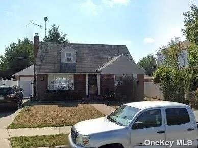 Maintained brick cape home, four bedrooms, two bathrooms, living room, kitchen.