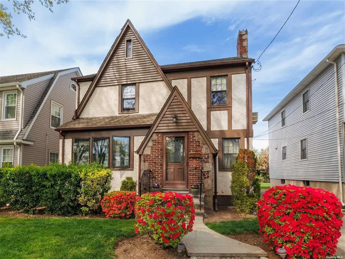 Welcome to beautiful Floral Park! This lovingly maintained 2044 sf Tudor sits on a wonderful block in the heart of the Village. Enter through the foyer into an elegant formal living room with wood-burning fireplace with a den/office to the side. The large dining room opens up into a huge, renovated eat-in kitchen with new appliances and a cozy breakfast nook, powder room and an enclosed porch - the perfect spot for morning coffee or relaxing after a long day. Second level features a large primary bedroom, two additional bedrooms, a gorgeous brand new (2023) hall bath and a finished, walk-up attic with plenty of bonus space and storage. The semi-finished basement can be the perfect hang-out space with separate laundry and utilities. The private backyard is ideal for entertaining with a lovely patio. Great location within blocks to shops, schools, restaurants, L.I.R.R. and more. This classic Floral Park beauty features gleaming hardwood floors and vintage charm throughout plus newer windows, roof and plumbing. Esteemed Floral Park-Bellerose schools. All this magnificent home needs is your personal touch to make 299 Carnation your forever home!