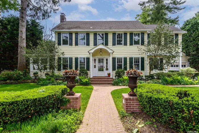 Some homes just command our attention. 2 Litchfield is one of those striking homes. Surrounded by lush hedges and featuring its signature walkway planters, this home exemplifies classic architecture with modern upgrades and convenience. The spacious center hall entryway is flanked by a formal living room with wood burning fireplace and elegant French style sliding glass doors that lead to a private deck and backyard. The renovated and expanded kitchen with luxury appliances opens to a large dining area perfect for family gatherings. The comfortable flow continues with the open floor plan and adjoining TV lounge. The window surrounded sunroom doubles as a multi person office. Lined with wall-to-wall built-ins, it&rsquo;s a peaceful retreat for work or relaxation. The practical layout continues with a convenient mudroom off the driveway and kitchen and discreet powder room on the main floor. Upstairs, the luxuriously sized primary suite with 12+&rsquo; ceilings includes his and her walk-in closets and an updated ensuite bathroom. Completing the second level: three additional bedrooms, a second full bathroom, and access to a large walk-up attic providing ample storage space. The lower level is another unexpected bonus- finished to a high standard with extensive storage and cabinetry rarely seen in foundation level spaces. Wainscoated walls are actually custom cabinet doors opening up to house all your toy, book, sports and game collections. Again, large modern laundry room with additional storage room. Well organized and accessible mechanicals. Modern necessities such as multi-zone gas heating, central air, and a two-car garage with another walk up attic, add comfort and convenience. Additionally, charging for your electric vehicle is already driveway ready. Situated in an enviable location, the property is a flat, short distance to the town, restaurants, parks, LIRR and nearby upper schools campus, placing it in one of the area&rsquo;s most desirable settings. 2 Litchfield - an opportunity to own one of Port Washington&rsquo;s most special and iconic homes.