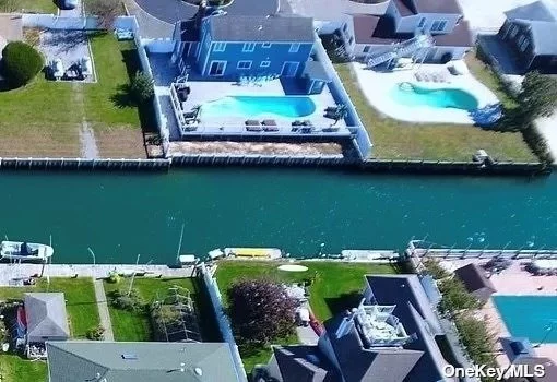 Spend your summer in the Hamptons at the Beach! Waterfront Beach House in Private community with Canal Access, private beach access, community playground, resort backyard with heated gunite inground pool and cabana bar, entertainer&rsquo;s Haven, private laundry, gourmet viking kitchen