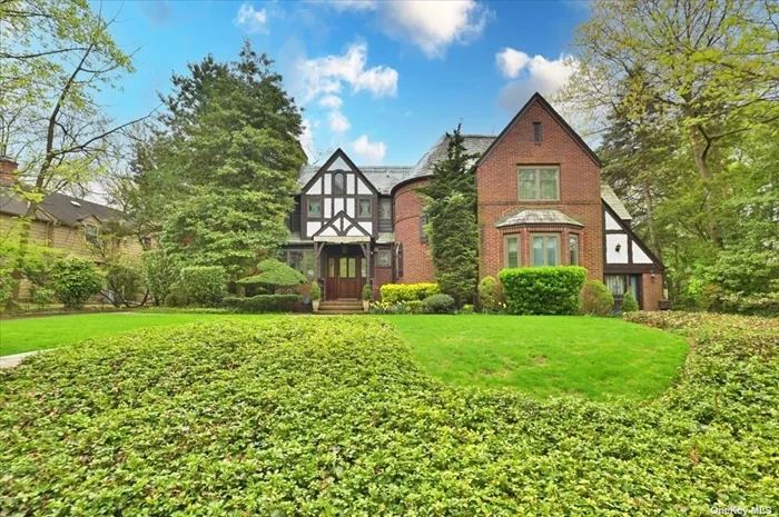 Desirable Village of Russell Gardens Charming One of a Kind Tudor. Outstanding Location across from Natural Wooded Green Space to View the Seasons Change. Old World atmosphere with Original Details updated for todays lifestyle. Privacy in many rooms, separate front door entrance to flexible space for office to work at home or additional bedroom. Large eat in kitchen, family room with outdoor balcony, built in storage shed, gas barbecue, radiant heated bathroom floors, Generac Generator, attached 2 car garage with driveway / patio. Close to public transportation, LIRR, Bus N20, N21, all major highways. Designated for Lakeville Elementary School and South Middle and High School. Private Russel Gardens Pool and Tennis Amenities for $1400 per year.
