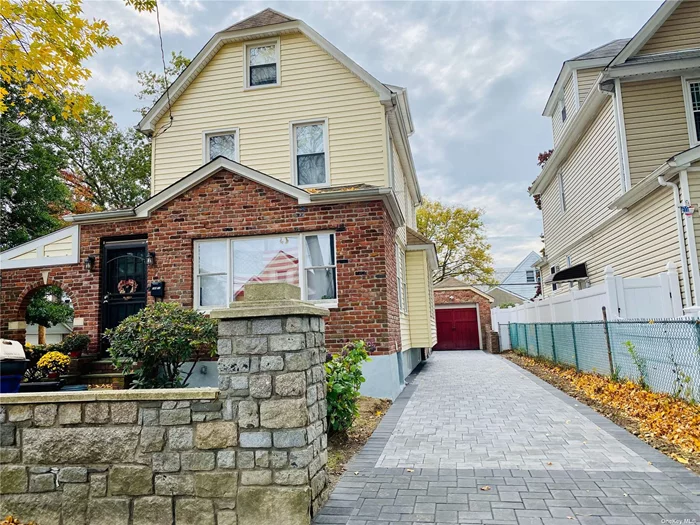A gem of a home. This eye-catching colonial is on an oversized 6, 600 square-foot lot on a quiet tree-lined street. This corner property has a unique look after decades of renovations and improvements.  **Great location on a quiet street near transportation and popular stores like Chase Bank, Starbucks, Queens Public Library, supermarket, Dollar Tree, CVS, Staples, and many restaurants. Steps away from public transportation bus (Q36) and LIRR train directly to midtown Manhattan.  **District 26 is an exceptional school district. The public elementary school is blocks away, and a private school is even closer.  **The gigantic yard features a stone wall, multiple flower beds, a pond, a fire pit, an Arizona room, and brick facades.  **The beautiful driveway was recently re-laid and can fit multiple cars.  **The garage is finished with an air conditioner and heated floors, suitable for exercise, lounging, or remote work. It also has track lighting and multiple outlets.  **The spacious basement is partially finished, waiting for you to design the den or playroom of your dreams. The basement includes a full bath, washer, dryer, water heater, and boiler. This house uses gas, not oil.  **The comfortable first floor features a recently renovated eat-in kitchen with generous counter space, stove, dishwasher, refrigerator, pantry, and half bath. Adjacent is the Scandinavian decor dining room, designed suitable for a table that fits 8-10 people. The Northern European theme continues into the living room and a separate sitting room, which may be used as an office.  **On the second floor, you&rsquo;ll find a full bath and two comfortable bedrooms, one just renovated last year.  **The spacious attic is fully-finished, which can be used as a bedroom, den, or playroom. There are also five storage cubbies.  **Recent updates to the property (years are approximate): **New washer 2016 **New dryer 2016 **Partially finished basement 2016 **Finished garage 2017 **Finished attic 2017 **Updated electric 2020 **New boiler 2020 **New radiator covers 2020 **Reinforced foundation 2021 **Replaced driveway 2021 **Updated electric again 2021 **Coated perimeter stucco 2022 **Updated 2nd-floor bedroom 2022 **Replaced line to city water with copper 2022 **Updated kitchen and 1st floor bathroom 2023 **New basement bathroom toilet **New front sidewalk replaced by city **Replaced numerous 1st floor windows 2024. Sold in As Is Condition.