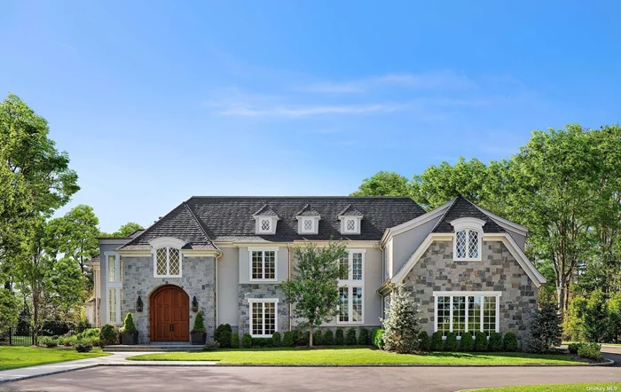 Nestled within the prestigious gated community of Stone Hill Muttontown, this exquisite stone and stucco Cotswold residence stands as a testament to luxurious living. Completed in early 2019, the home boasts an alluringly youthful appeal yet emanates a sense of timeless sophistication. Upon entering the home, one is immediately struck by the soaring ceilings, expansive floor plan, and natural light. The fabulous great room with coffered ceiling, stone fireplace, and wall of French doors overlooking the infinity pool and magnificent property, is truly the heart of the home. From the great room the home flows into a sophisticated open kitchen, butler&rsquo;s pantry, formal dining, and game room/sitting room. A second primary bedroom is tucked away on the first floor for privacy and comfort. Overlooking the dramatic entry foyer the magic continues on the second floor with a jaw dropping four room primary suit, with its inviting bedroom, sitting room with fireplace, wet bar, a spa bath, plus a dressing room that dreams are made of. A custom-built office, and 3 additional bedrooms complete the second floor. The lower level offers a private gym, handball court, bunkbed room/guest room, work room, and ample storage. An elevator to all 3 floors, a 4-car garage, a high-tech audio and security system, and custom details throughout perfect this captivating home. The outdoor oasis beckons with a sparkling infinity edge pool, cabana with outdoor kitchen, and lush landscaping, offering an ideal retreat for relaxation and entertainment alike. Beyond its stunning aesthetics and amenities, this home transcends the ordinary, embodying the epitome of modern elegance and comfort. Meticulously designed and meticulously maintained, it surpasses the standards of new construction, exemplifying the unparalleled craftsmanship of its esteemed builder. From the sleek lines of its exterior to the thoughtful layout of its interior, every detail has been carefully curated to create a living space that is both strikingly beautiful and supremely functional. The home stands as a beacon of sophistication, offering a sanctuary of unparalleled luxury and tranquility. Truly, it represents the pinnacle of upscale living.