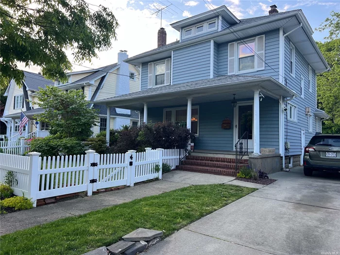 Spacious 4Br Colonial with rocking chair front porch, tall ceilings, living room with fireplace and a huge private park like yard! Updated gas boiler and hot water heater. Rockville Centre Sd#21 Schools. Freshly painted and ready to move in.