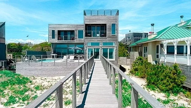 418 Ocean Walk is an architect-designed oceanfront home built to current building and elevation codes from the ground up in 2016. It features 12&rsquo; ceilings on the main level and 10&rsquo; ceilings on the upper level. The main level includes an open kitchen with Miele appliances, suspended wood burning fireplace, powder room and walls of glass looking out to the mahogany pool deck and ocean. The upper level features three ocean facing bedrooms with balconies, all of which are ensuite with large closets, and a vented washer dryer. There are two master suites with king beds and showers with views to the ocean as well as a queen sized suite. A large hot tub is located on a separate roof deck with panoramic unobstructed views of the ocean, bay and Fire Island itself. The pool deck - open yet protected from winds - comfortably accommodates outdoor dining, separate areas for lounging and a heated oceanfront pool. There is direct beach access via a private walk built in 2021. In addition to new furnishings, the wood floors have been just been refinished and new remote operated blinds have been installed in the bedrooms. One of three HVAC systems is brand new. The others are less than three years old. Pool heater is 2 years old. Roof was recoated less than two years ago. House is fully winterized, including a basement the size of the ground floor with high ceilings that functions as storage and could include a home gym.