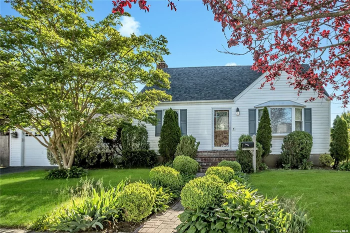 Beautifully Expanded Cape /4 Bdrs and two full baths/ Den with Sliding Doors to BackYard/Finished basement/Central Air/updated electric/Garage/Updated through out/Gas on the Block.