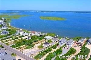This beautiful Dune Rd beach home located on the bay is ready for the summer of 2024.. This home has 3 bedrooms, 2 baths and an open living floor plan. Ocean access across the street. Great location on Dune Rd. Bay access from the property with use of kayaks and paddle boards. This is the front home of a 2 home complex. Pool access to the 2nd home when owners are not there. Relax and enjoy your summer with all the wildlife that surrounds the property.