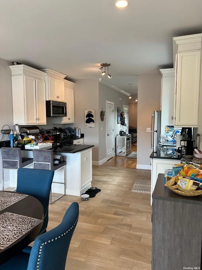Modern Waterview (overlooking creek)Duplex in Manhasset Isle. Built in 2015, featuring LR/DR & modern kitchen on main floor. Balconies on 1st & 2nd levels. Upstairs offers primary BR w/high ceilings & bath, +1 addtl BR, Full bath, and loft area. Hardwood floors, CAC, gas heat, finished walk-out lower level + laundry. Off-street parking for 2 cars.