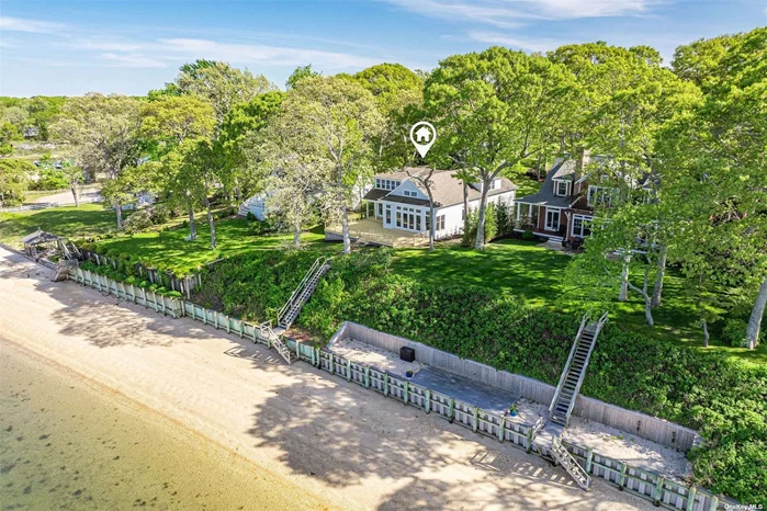Exceptional bay front in the coveted Reydon Shores section of Southold with 62 ft on of water frontage and private staircase to beach! This home was completely rebuilt and redesigned in 2011, with bright open floor plan, vaulted ceilings and breathtaking water views. The kitchen has a unique mid century modern vibe with colorful backsplash, countertops and sleek modern cabinets. The first floor primary suite has a large marble en-suite bathroom with shower and separate soaking tub. The primary bedroom has French doors leading out to the waterside deck and stunning water views. Upstairs there are another 2 bedrooms and 2 full baths, plus an additional room that could be used an another bedroom, den, office and more. There is a full basement and oversized 2 car garage.  Reydon Shores has its own private community beach as well as its own private marina. Boat dockage subject to availability. Property is set on a high elevation in X Zone- No flood insurance required.
