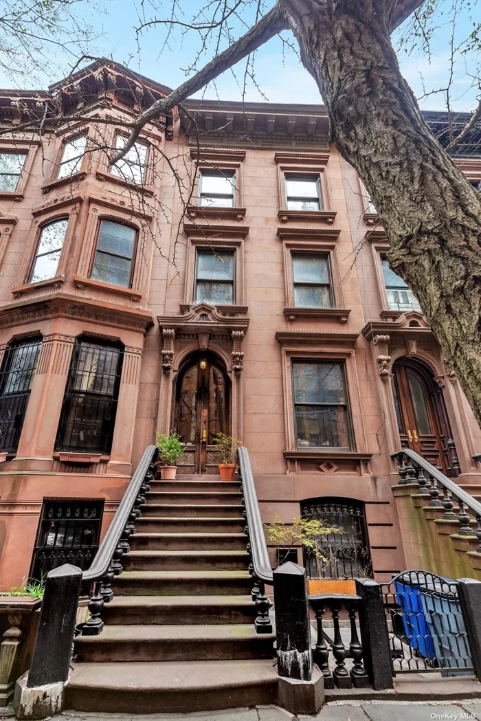 Live with Income: 4 BR Upper Triplex plus Garden level floor thru income producer! Come home to a colorful piece of remixed history in the heart of Fort Greene, Brooklyn! This turn of the century brownstone, dating back to 1899, is nestled next to Fort Greene Park and is surrounded by vibrant cultural hubs, making it a prime location for those seeking a unique blend of historic charm and modern convenience. An artistic, contemporary spin on the classic design gives this home a lively personality, filled with joy and fun. As you step inside, you&rsquo;ll be transported back in time by the original details that have been meticulously preserved, including the hardwood floors, lincrusta plaster details, Italianate marble fireplaces with stone mantels, and a carved balustrade, contrasted with high-design contemporary chandeliers, industrial fixtures and delightful, bright colors in every room. This stunning triplex has been gut renovated to offer the perfect combination of classic and contemporary living, pairing an ultra modern gourmet kitchen with classical archways, pocket doors, moldings, medallions, niches and carvings throughout. With three full floors, you&rsquo;ll have ample space to create your dream home. Three bedrooms are perfectly sized, providing large, comfortable living spaces that are filled with natural light. A top floor artists&rsquo; studio makes for a lofty fourth bedroom with natural wood beamed ceilings and heritage wide plank pine floors. Enter up the front stoop, through tall carved double doors, into an entry foyer where you&rsquo;re greeted by a central open kitchen with dining area. A Bertazzoni gas range is surrounded by custom cabinets which also enclose the Bosch dishwasher below butcher block countertops with lots of prep space. Double pocket doors lead through a high molded archway into the living room, which has a wood burning fireplace, very high ceilings, a wall of built-in bookcases and two tall windows overlooking the rear garden. A private outdoor deck is accessible through French doors from the living room. The deck runs the entire width of the house, and it overlooks the landscaped garden below. Beautifully curated plants, flowers, trees, stones and a babbling fountain and koi pond provide a natural layer of peace. As you climb the staircase to the second floor, you&rsquo;ll note the built-in video displays contrasted with a beaux arts niche at the second floor landing. This floor has two bedrooms, one at either end of the house, each with its own Bisazza mosaic tiled bath. Bedrooms have good closet space, high ceilings, unique chandeliers and hardwood floors. One more flight up reveals a traditional bedroom on the front of the house with the loft-like artist studio on the rear, which also has a laundry room and very colorful tile bathroom. As an architectural epiphany, glass has been inlaid within the center hallway floors on each level to allow natural light from the top floor skylight to penetrate the center of this elegant house, adding a distinctive lighting element not found in other brownstones. The prime Fort Greene location is very close to public transportation, iconic brands such as Apple Store, Whole Foods, and Target, as well as cinemas and a diverse range of neighborhood stores. Fort Greene Park, with its tennis courts and picturesque tree-lined streets, is just a stone&rsquo;s throw away, offering a plethora of outdoor recreational activities and events. Living in this historic district means being surrounded by an eclectic choice of fabulous restaurants, adding a gourmet touch to your everyday life. The combination of the historic charm of the brownstone, the cultural richness of the neighborhood, and the convenience of modern amenities make this property the rarest of opportunities for you to call home.