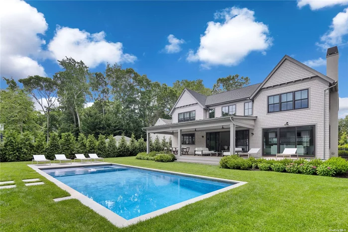 This +/-6, 000sqft. new construction transitional masterpiece is the quintessential Hamptons home located in Bayview Oaks, a Southampton waterfront community with access to Peconic Bay. You are greeted by the charming covered porch as you enter the double-height, sun-filled foyer fully outfitted with 8-inch character grade hardwood floors, custom millwork and Emtek finishings. The sprawling first floor boasts a formal dining room that effortlessly flows into the custom gourmet chefs kitchen, quartz counter tops, custom cabinetry, an oversized island providing additional prep space and storage with barstool seating, and breakfast nook with full views of the grounds. The great room, centered around a custom fireplace flows to all rooms for effortless entertainment. The first floor additionally features a first floor junior primary bedroom with ensuite bathroom, currently furnished as a den, mudroom, one and a half bathrooms.The second floor boasts the primary suite with the primary bathroom, outfitted with double vanity sinks, freestanding soaking tub, and elegant glass shower, custom walk-in closet and custom fireplace. Three guest bedrooms, all accompanied by ensuite custom bathrooms and closets, as well as a laundry room complete the second story. The lower level, equally grand and spacious, features a recreation room fully outfitted with a bar for entertainment. The sprawling grounds feature a 40&rsquo; x 18&rsquo; heated gunite pool & spa with bluestone patio and oversized 3-car garage with artist studio above. Attached to the home is a covered porch, featuring both a dining and lounge area, as well as a covered lounge centered around the outdoor fireplace & bar attached to the garage. All just moments away from the charming shops, dining, docks, bay beaches and entertainment Sag Harbor & Southampton Village has to offer!