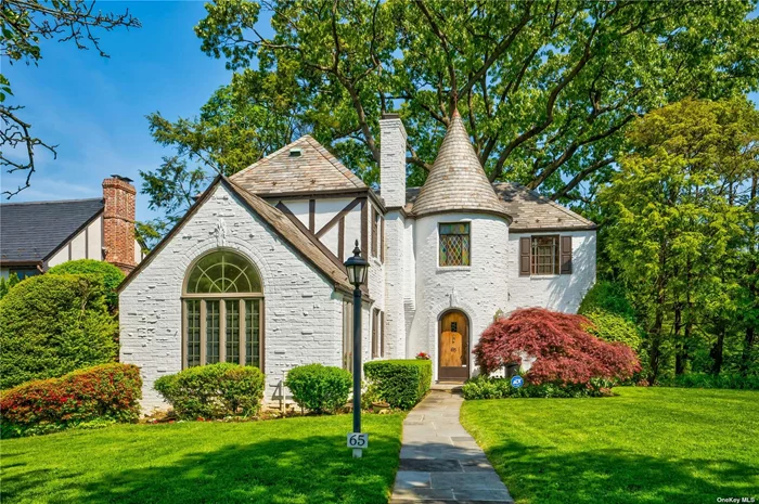 Beautiful French Normandy Tudor with spectacular curb appeal. Convenient to town & train
