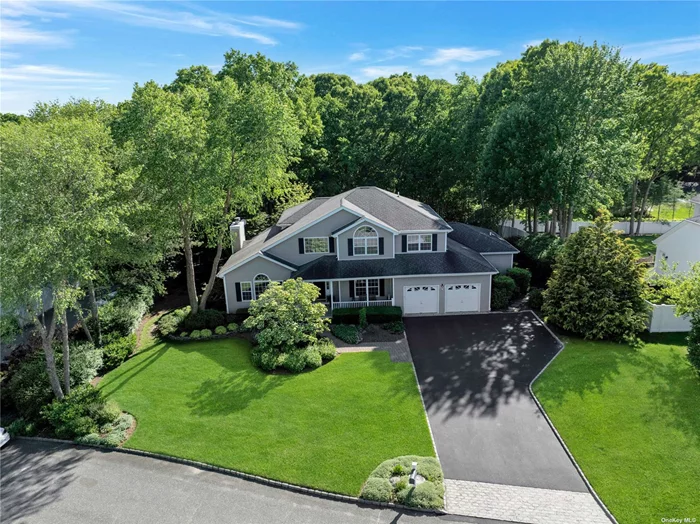 This elegantly renovated colonial residence, situated in the highly sought-after Pond Estates of Setauket, showcases four bedrooms and three and a half baths. The main floor features a versatile master bedroom suite or guest quarters, comprising a bedroom, full bath, and a den or office area with direct access to a private backyard. Recently remodeled in 2022, the kitchen exudes sophistication with Corian countertops, stainless steel appliances (including a wine fridge), a spacious center island, and abundant counter space. The roomy den offers a cozy gas fireplace, complemented by formal living and dining areas, a powder room, well-appointed mudroom, ample storage, and a sizable laundry room. Upstairs, the second floor unveils a grand master suite with cathedral ceiling, dual walk-in closets, and a luxurious bathroom featuring a stand-up shower and tub, also updated in 2022. Two additional generously sized bedrooms and another full bathroom complete the second floor. The basement presents a partially finished rec room and an extra office area, with a substantial unfinished area ideal for conversion into more living space as needed. This residence boasts central vacuum, central air conditioning, gas heating, recessed lighting, hardwood floors, abundant windows for natural light, a delightful Trex deck, and a paver patio. This impeccable and luxurious home is an opportunity not to be missed.