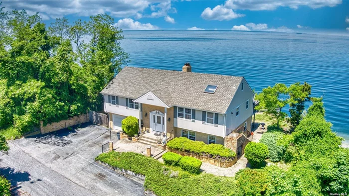An unparalled location set proudly into the distinguished waterfront bluffs of Rocky Point. Elevated unobstructed and panoramic Sunrise and Sunset views over Long Island Sound. Perched directly above Friendship beach, access is just steps away from your front door. Enter into the main living area with abundant water views throughout. The sun-drenched living room is made cozy with a wood burning fireplace and open to the dedicated dining area, with glass sliders to your back deck that is any water lover&rsquo;s dream location. The bright white eat-in kitchen has ample space for prep and storage along with room to entertain. Water views from bed in your master bedroom with egress to the back deck and an en-suite bath. 2 guest bedrooms and a full hallway bath round out the upper level. The lower level has a den or office with a separate laundry space, full bath and direct access to the 1 car garage. Through a walkout entrance in the backyard the lower level also has potential for a Mother-Daughter/ income producing opportunity with proper permits. Water views abound once again through the lower level living area with another wood-burning fireplace, food prep, large bedroom and a full bath.